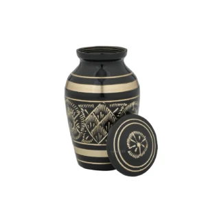 Open black and gold brass cremation keepsake urn, showing interior compartment, detailed lid.