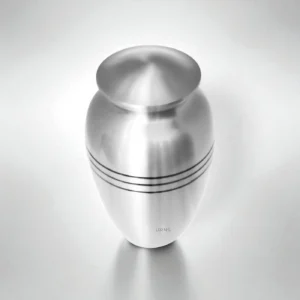 Top view of Lineage Lumina silver cremation urn, showing lid against clean background.