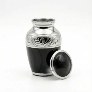 Open Black Elegance keepsake urn with silver engraved band and threaded lid resting on side