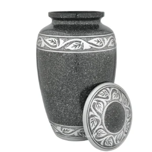 Eternal Laska Adult Cremation Urn in cream white, with its intricate hand-etched silver lid resting beside it.
