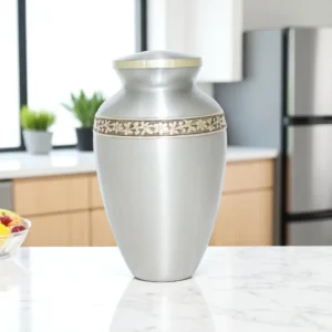 Close-up of floral brass band on Harmony Crest silver urn