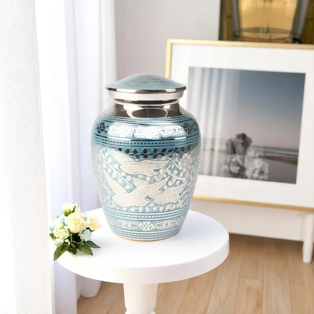 Silver and sky-blue Dove Whisper urn with delicate engraved doves and floral motifs, designed for dignified memorials