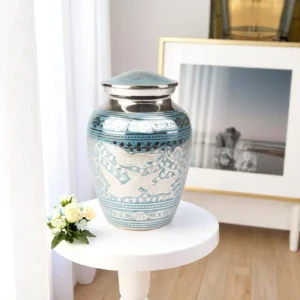 Silver and sky-blue Dove Whisper urn with delicate engraved doves and floral motifs, designed for dignified memorials