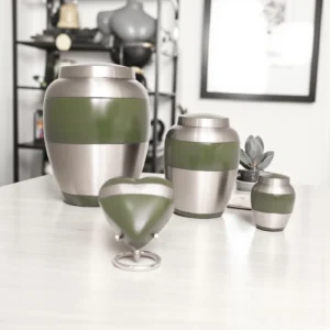 Range of sage green and silver keepsake urns, size comparison for adult and small ashes memorials.