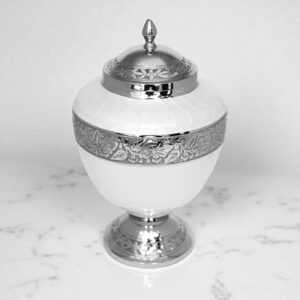 Elegant brass urn with pearl-white body and silver engraved accents