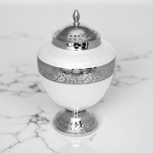 Brass cremation urn in pearl white with silver engraved floral band and lid