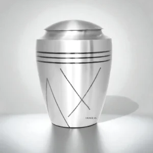 Front view of a brushed brass cremation urn with lid, minimalist studio background.