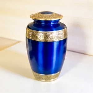 Traditional dark blue brass cremation urn with intricate gold etching and banding, full-size memorial ashes container.