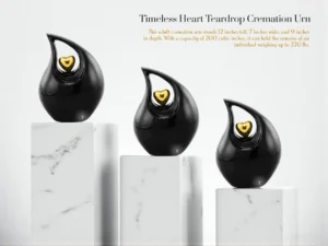 Three Black Timeless Heart Cremation Urns with Gold Hearts on Marble Slabs | Modern Memorial Urns for Ashes