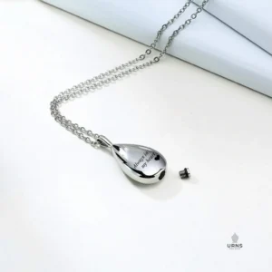 HDR enhanced image of the 'Always in my heart' teardrop urn necklace, shown open with its secure threaded screw cap removed to show the chamber for ashes.