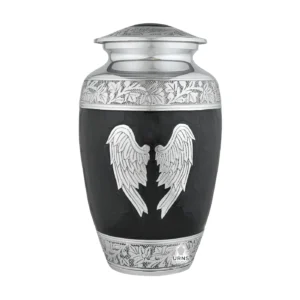 A large, black adult cremation urn for human ashes, featuring ornate silver angel wings on the front, with detailed engraved silver bands on the top and bottom.