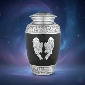 Black and silver 'Midnight Wings' adult cremation urn with angel wings, set against a serene celestial nebula background of deep blue and purple.