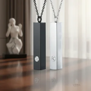 Black and silver Minimalist Bar Urn Necklaces with crystal accents, standing on a polished, reflective wood table in an elegant home setting.