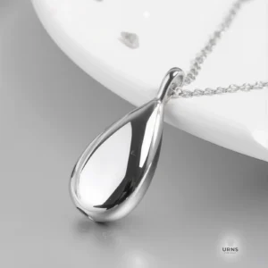 A polished silver Minimalist Teardrop Urn Necklace for ashes, a stainless steel memorial keepsake with a sleek, unengraved design.