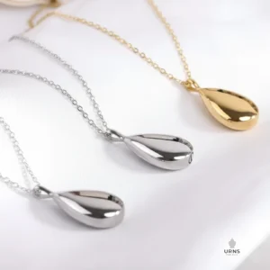 HDR enhanced image of the Minimalist Teardrop Urn Necklace, showing the polished Silver and elegant Gold variations side-by-side.