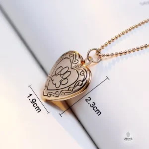 Gold paw print heart photo locket with dimensions (height 2.3cm, width 1.9cm) clearly marked for size reference.
