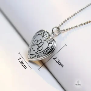Silver paw print heart photo locket with dimensions (height 2.3cm, width 1.9cm) clearly marked for size reference