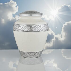 Elegant Silver Lining White Adult Urn on polished marble, highlighted by soft light from a cloudy, sun-kissed sky
