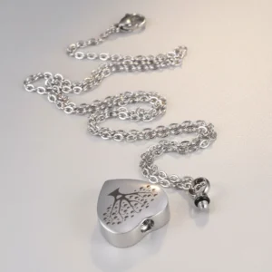 High-definition enhanced image of the Tree of Life heart urn necklace, showing its crisp engraving and polished stainless steel finish.