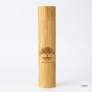 Small biodegradable bamboo scattering urn for pet ashes featuring a laser-engraved Tree of Life design and 'Forever in my heart' text.