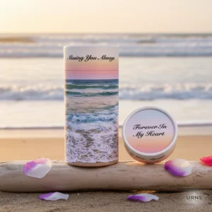 Hero shot of the Ocean Wave Scattering Tube Urn for ashes, featuring a calming blue ocean design and the inscription Missing You Always Missing You Never. This durable portable urn is displayed in a serene beach setting.