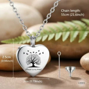 Stainless steel heart urn necklace for ashes featuring an engraved Tree of Life with birds and 'Forever in My Heart' inscription. Includes a funnel and rod filling kit for cremation jewellery.