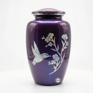 Studio front view of the Amethyst Twilight purple adult cremation urn featuring an iridescent hummingbird and flower design on a seamless white background.