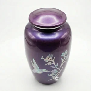 Slight top angle view of the Amethyst Twilight purple cremation urn, showing the secure threaded lid and the top of the iridescent hummingbird design.