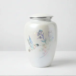 Studio front view of the Ethereal Flight white adult cremation urn with iridescent hummingbird design on a seamless white background.