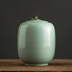 Calming light green ceramic cremation urn for human ashes, 24cm high, glossy finish, studio shot