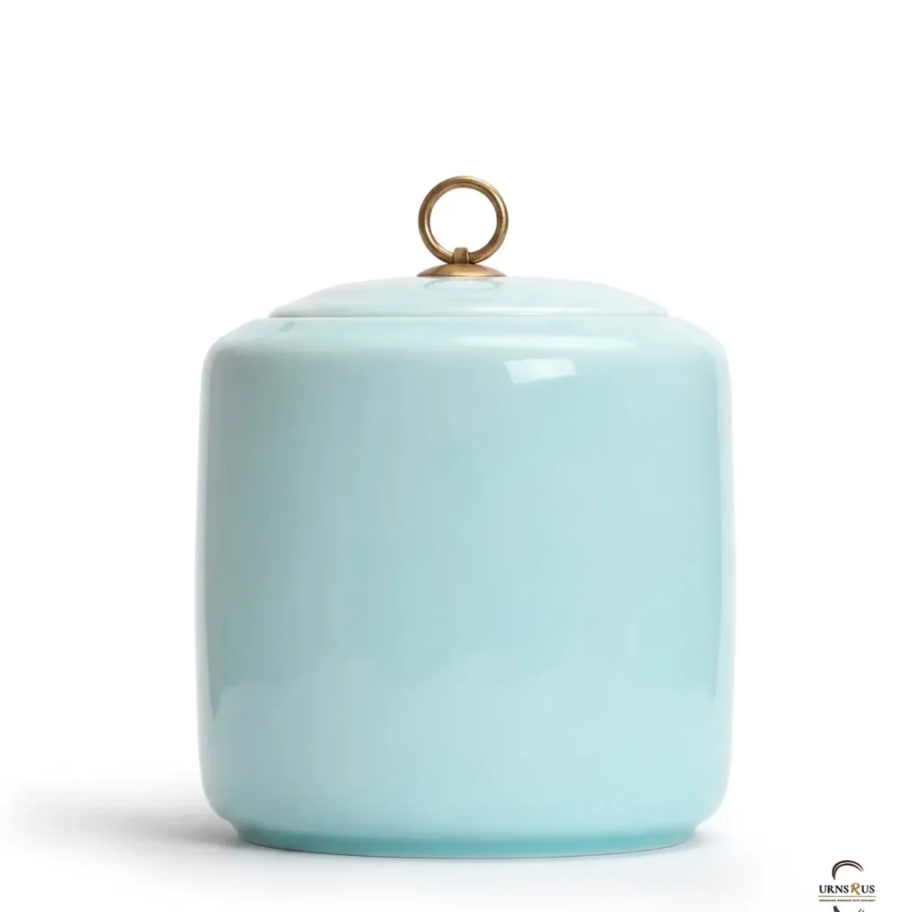 A high-gloss Celeste Zen Ceramic Cremation Urn featuring a sky blue finish and a brass ring lid, isolated on a clean white background.