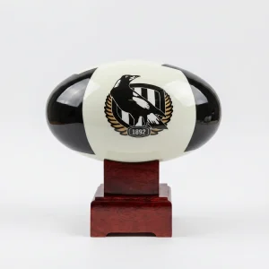 Front view of the Collingwood Magpies AFL Cremation Urn, featuring the classic black and white team emblem and resting on a polished solid timber base.