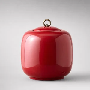 Elegant red ceramic cremation urn for human ashes, 24cm high, glossy finish, studio shot