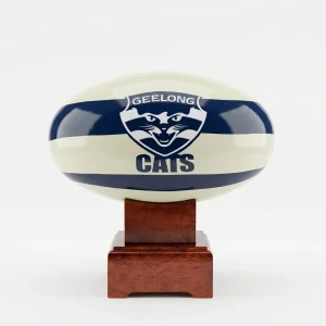 A high-quality Geelong Cats AFL Cremation Urn featuring a ceramic football on a polished timber base.