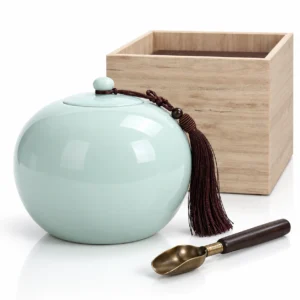 Serenity Sphere ceramic memorial urn in soft celadon green with wooden presentation box, tassel and brass filling scoop