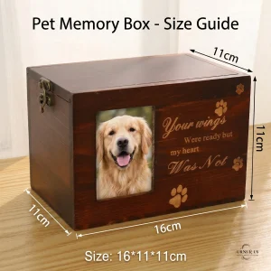 A dark wooden pet memory box size guide on a wooden table, showing specific dimensions: 16cm length, 11cm depth, 11cm height. It features a photo of a Golden Retriever and the quote 'Your wings Were ready but my heart Was Not'. Precise measurement lines with arrowheads clearly mark the dimensions for small pet memory box or urn function.