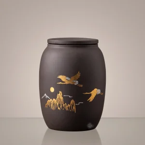 Tranquil Flight Gold Crane and Mountain ceramic keepsake cremation urn for ashes displayed on a clean studio background.