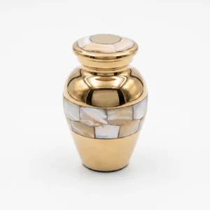 Small gold keepsake urn for ashes featuring iridescent pearl petal mosaic bands on a white background.