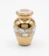 Small gold keepsake urn for ashes featuring iridescent pearl petal mosaic bands on a white background.