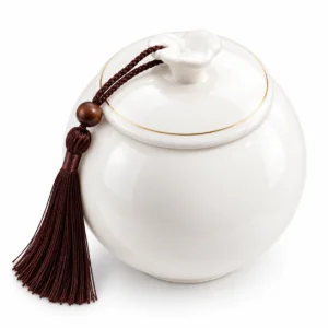 Top view of Serenity Sphere ceramic memorial urn showing fitted lid, decorative handle and brown tassel