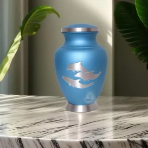 Side view of cremation urn with dolphins, blue memorial urn