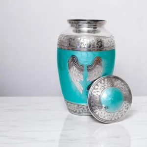 Cremation urn for ashes with lid off – green metal angel wings design