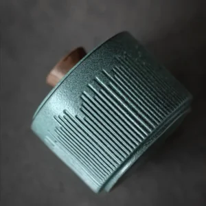 Small Pet Ashes Urn - Blue Ceramic Keepsake showing in hand showing base tilted view