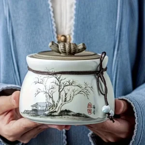 Small memorial urn for pet ashes with secure lid and decorative cord