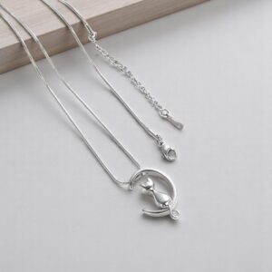 ash holding necklace cat and moon