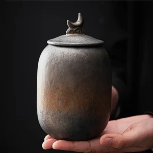 rustic antique urn showing size in hand