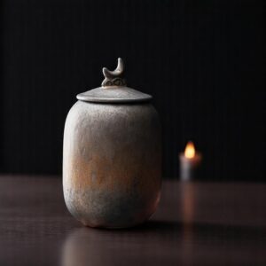 rustic finish and a unique crescent-shaped lid urn for ashes